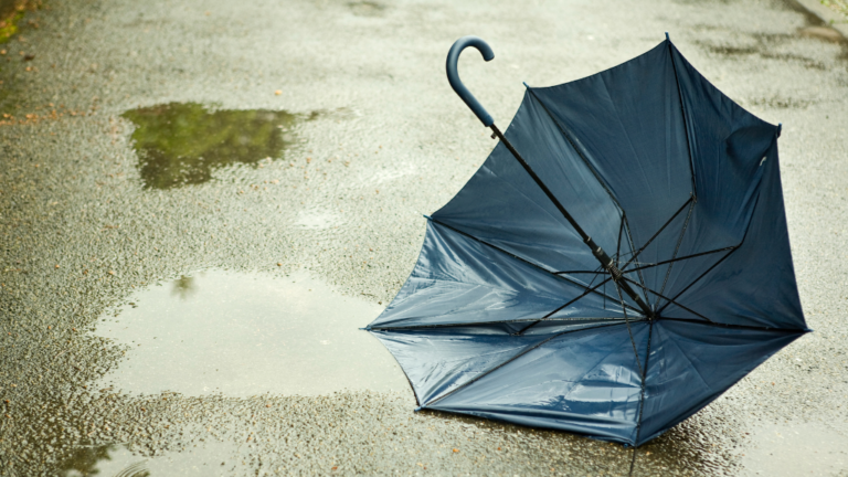 Underinsurance A broken umbrella lying on the ground